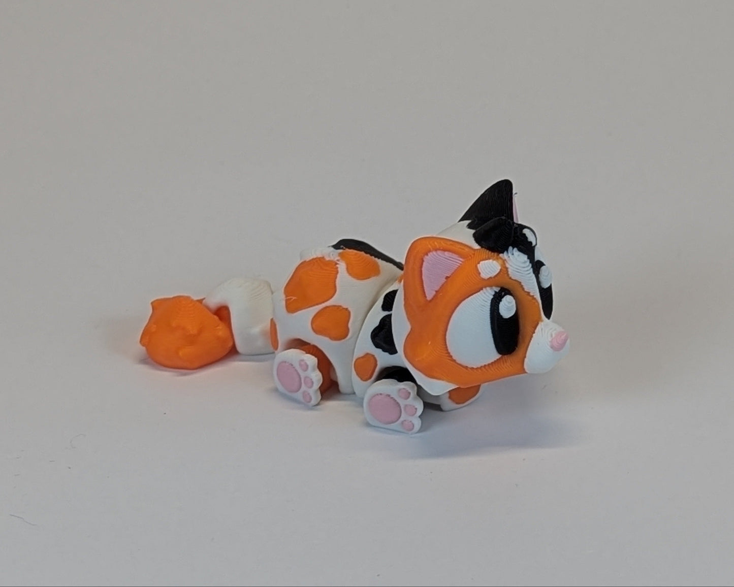 Calico Cat Cute Critter laying down facing right