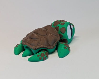 Green and brown turtle toy on a light gray background