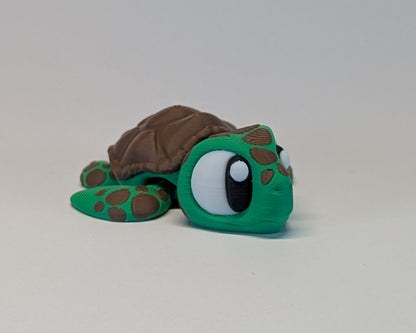 Toy turtle with a brown shell on a light gray background