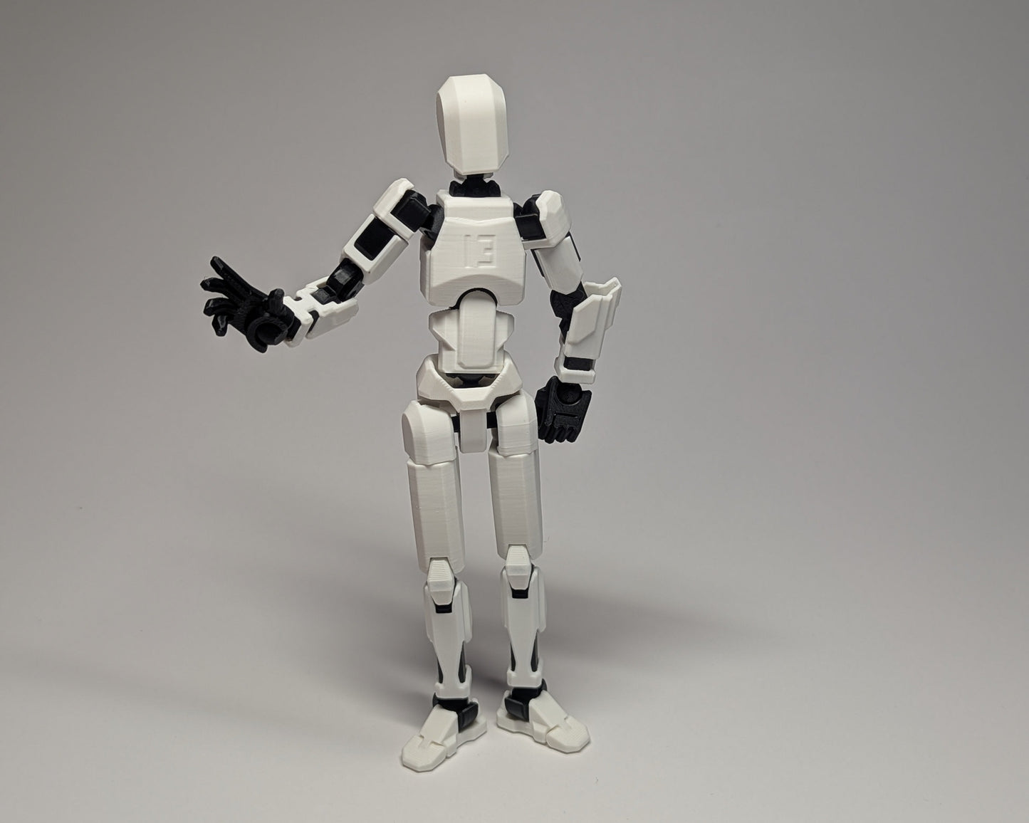 White robot figure with black accents on a gray background