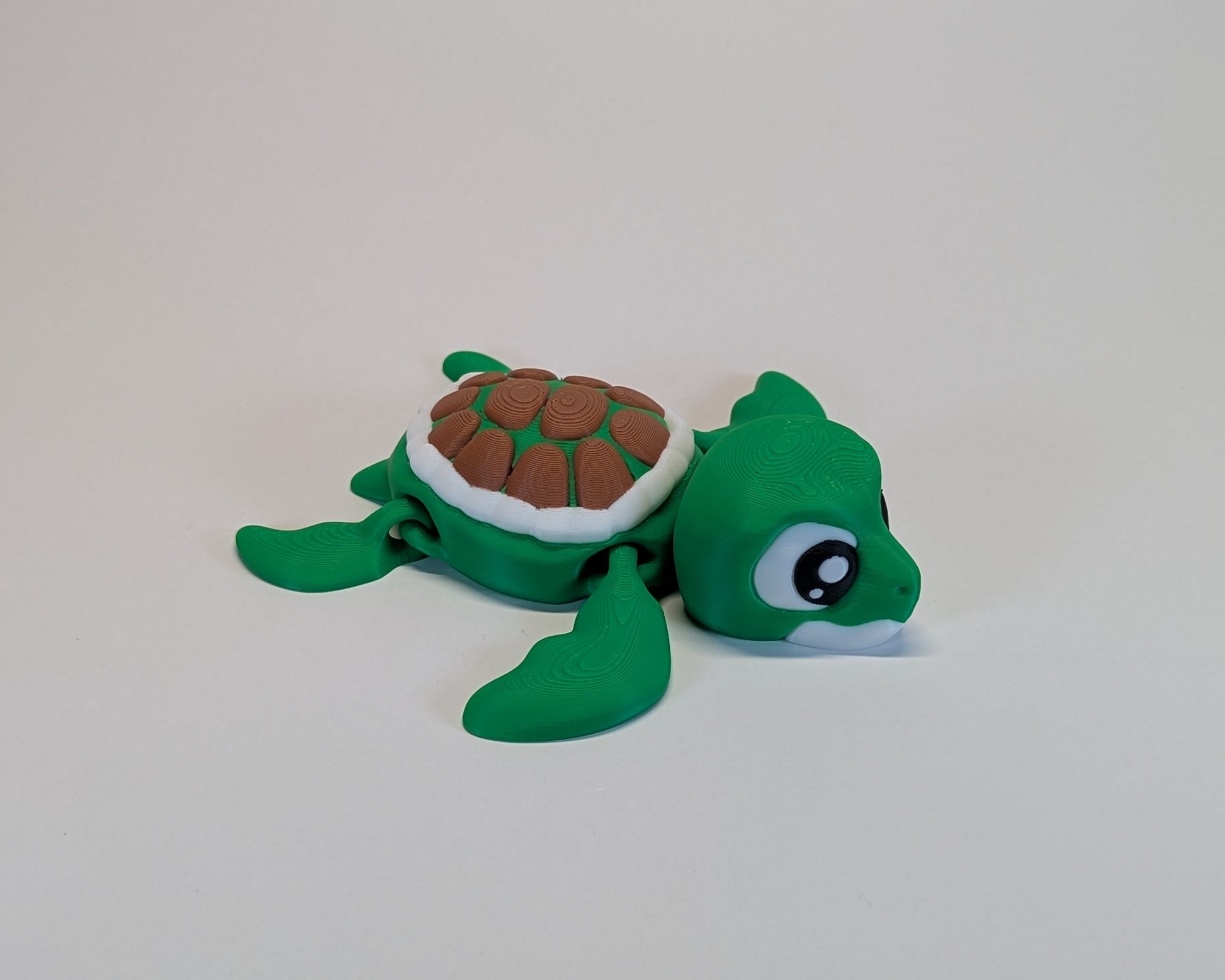 Small green turtle figurine on a white background
