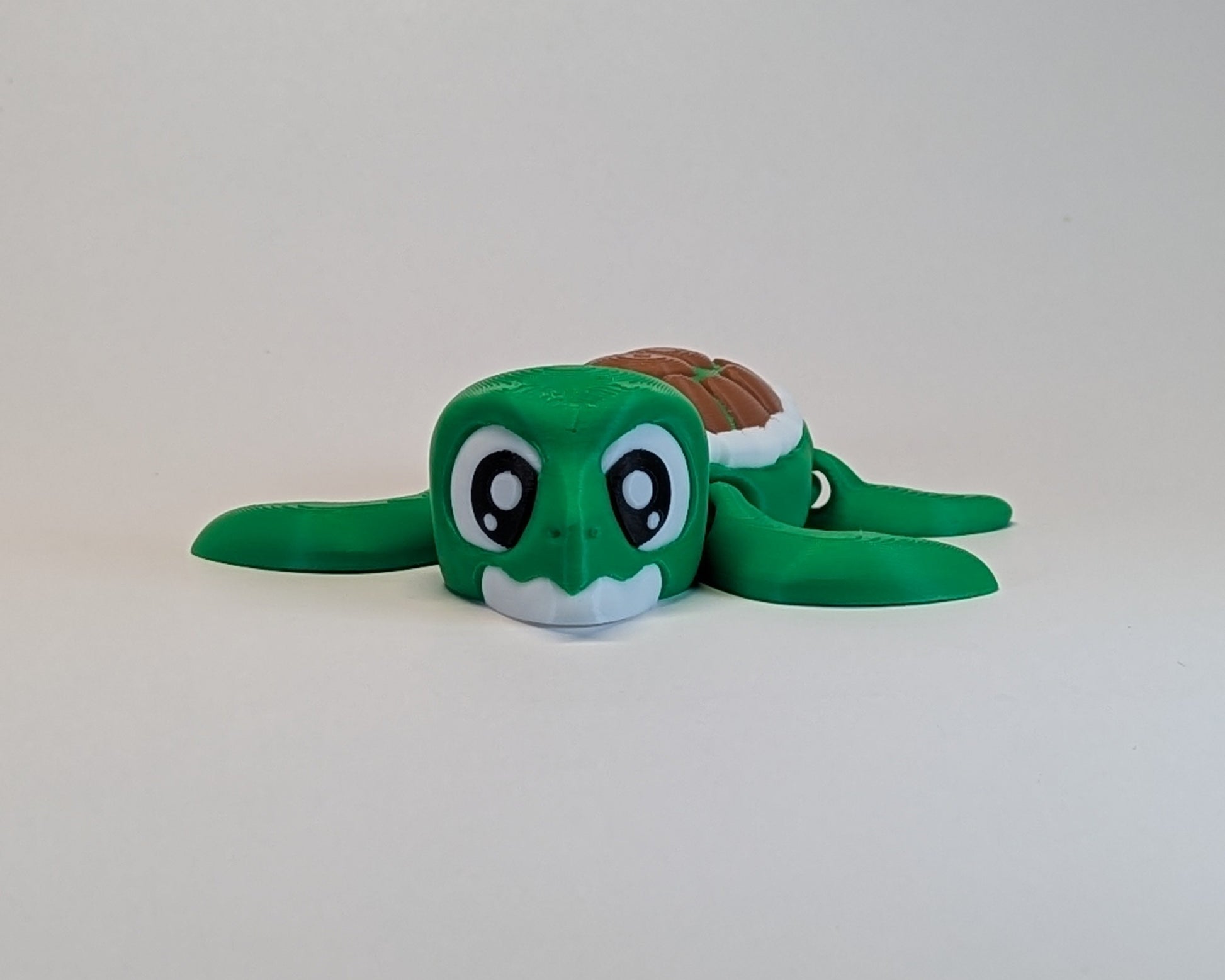 Green plush turtle toy on a light gray background