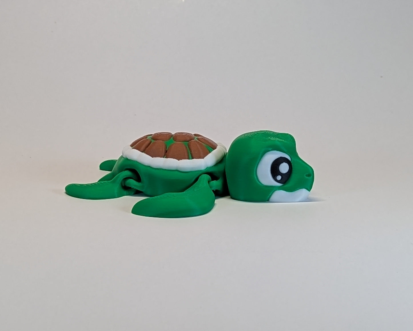 Green turtle plush toy on a white background