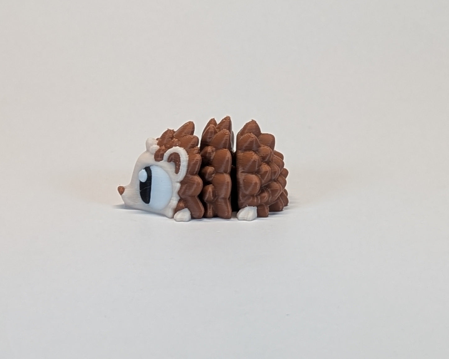 Small hedgehog cute critter on a light beige background