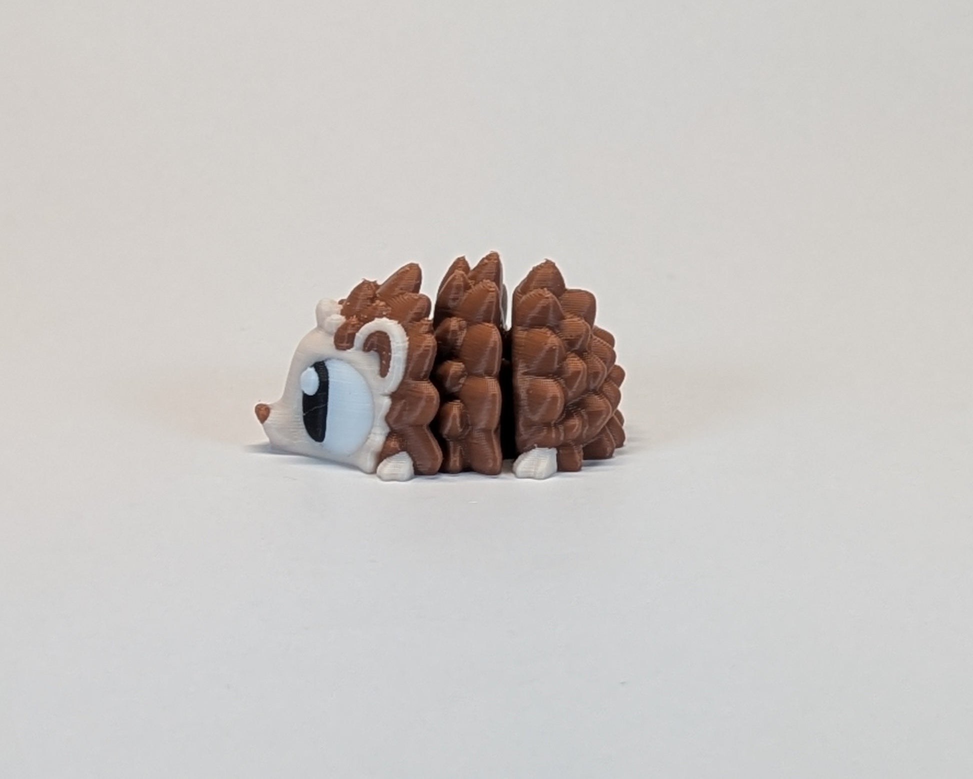 Small hedgehog cute critter on a light beige background
