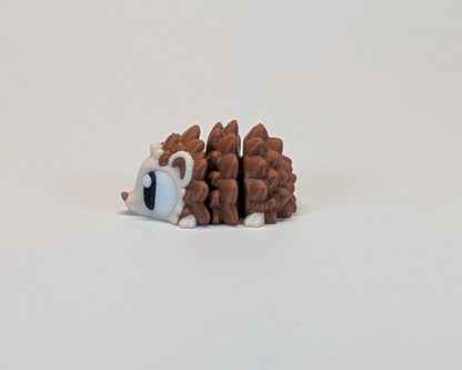Small hedgehog cute critter on a light beige background