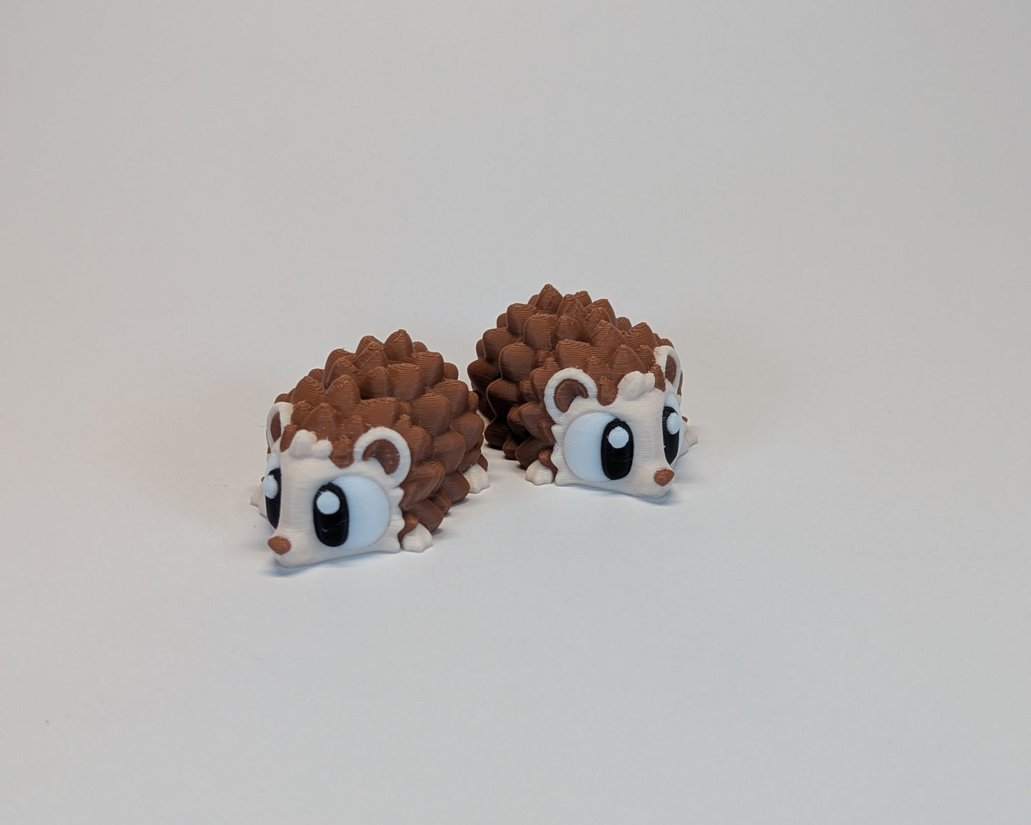 Pair of hedgehog cute critters s on a light gray background