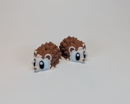 Pair of hedgehog cute critters s on a light gray background