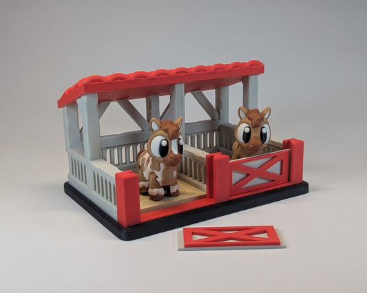 Tiny Habitat Stable with two toy horses on a gray background