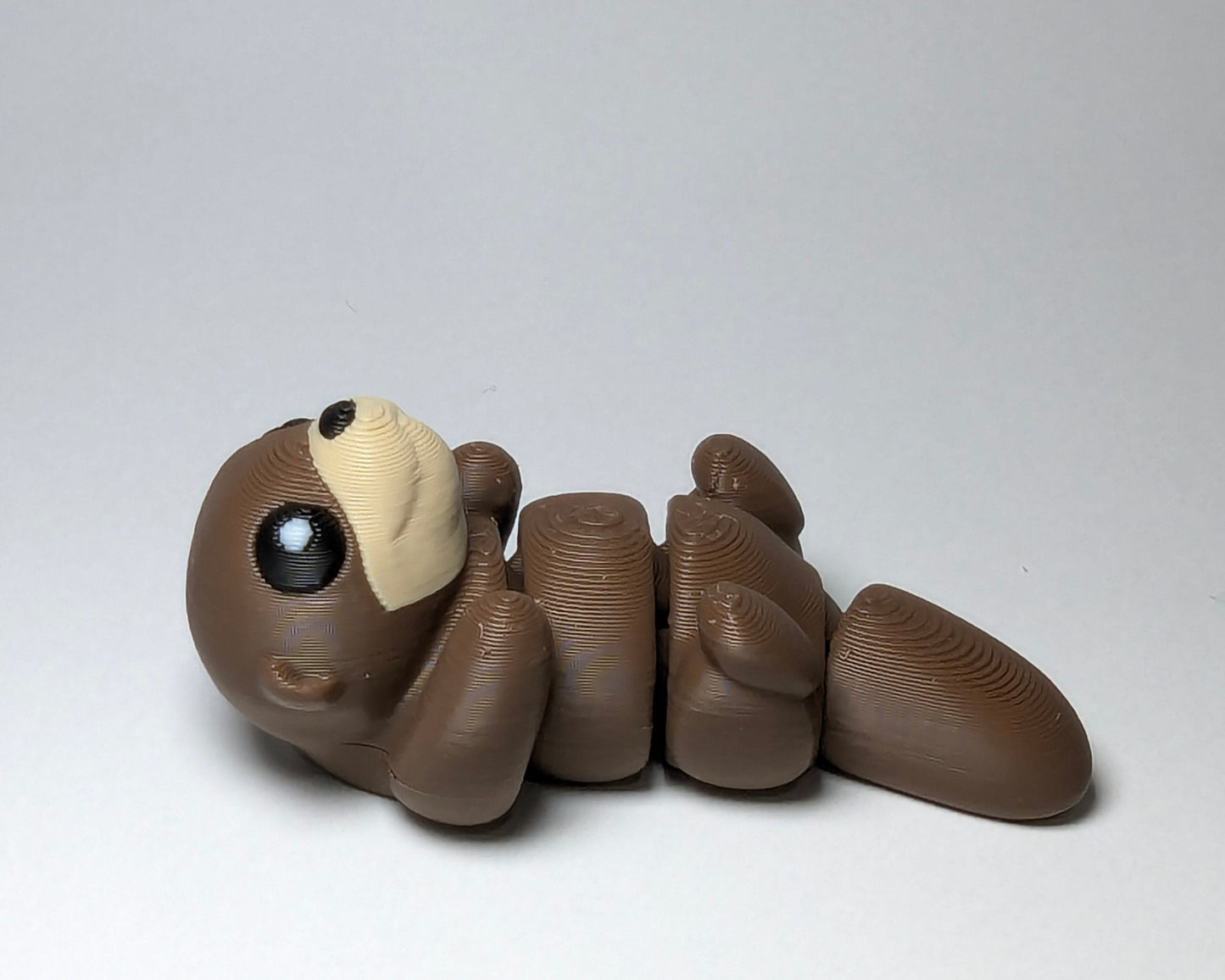 Otter Jiggle Pets Mini Flexi Animal on their back left facing