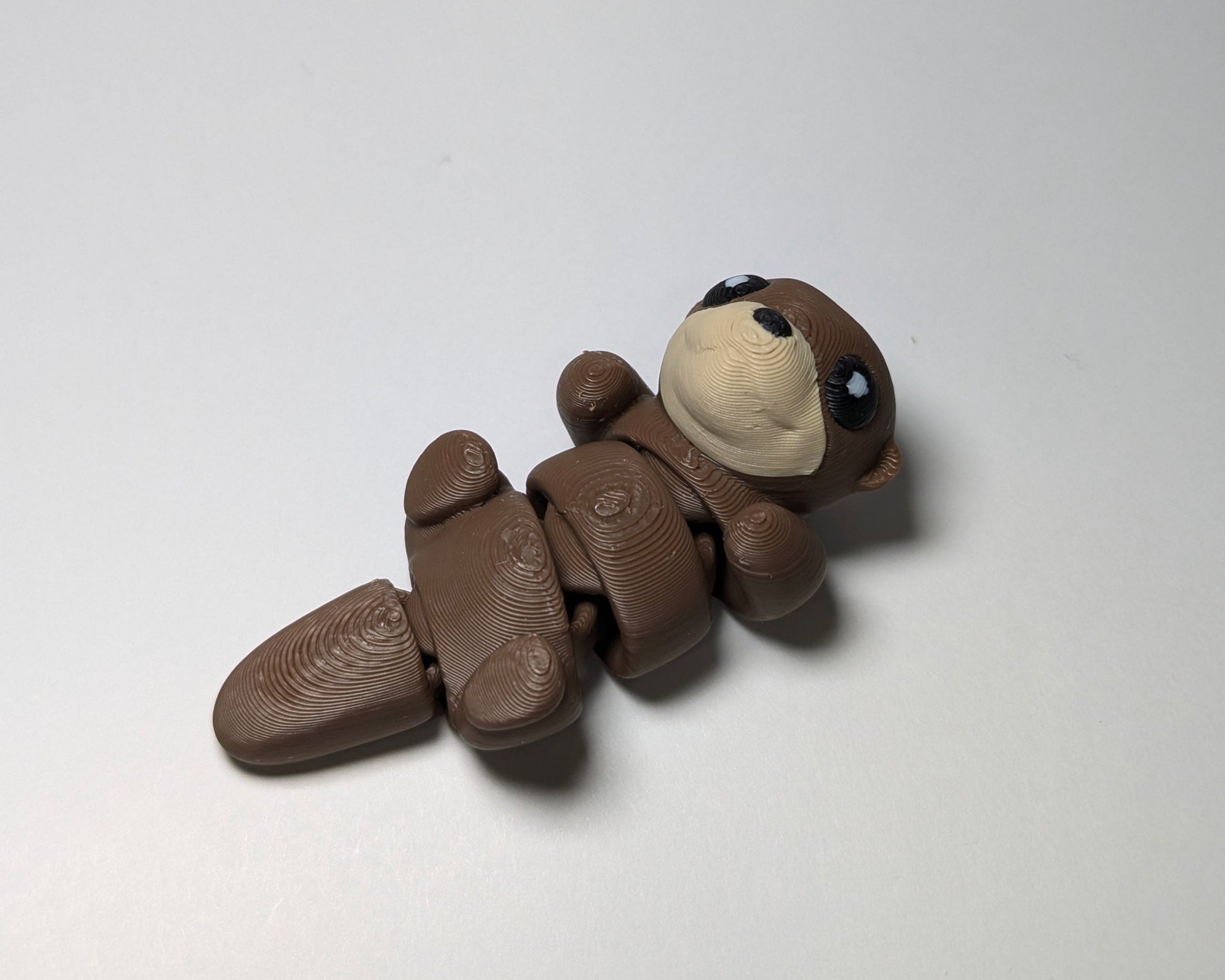 Otter Jiggle Pets Mini Flexi Animal on their back right facing