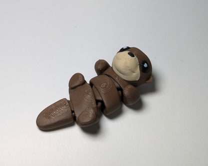 Otter Jiggle Pets Mini Flexi Animal on their back right facing